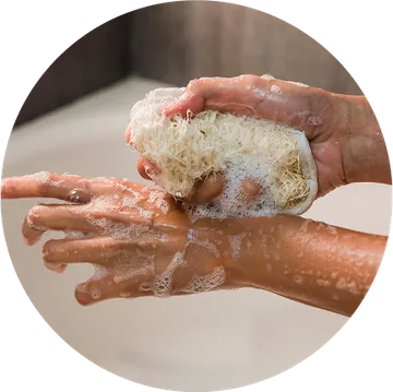 Washing with a soft sponge to cleanse the skin